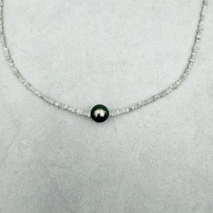 Ein zartes Glitzern wie Salzwasser und Sand auf der Haut. Elegant, zeitlos und dezent, aber dennoch luxuriös: eine einzelne edle dunkelgrau-schwarze Tahiti Perle, kombiniert mit einer zarten Kette aus gebohrten Rohdiamanten. Dieser Halsschmuck ist das perfekte Quiet-Luxury-Piece. Gesamtlänge: 43cm Tahiti-Perle: ca. 9,5mm Verschluss: Carabiner 585/-Gelbgold